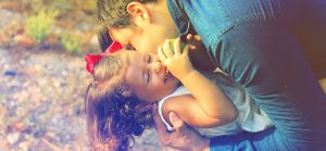 father holding and protecting children